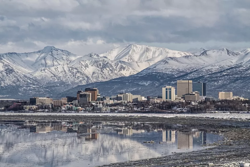 Downtown Anchorage with the snow covered Chugach Mountains in the background.